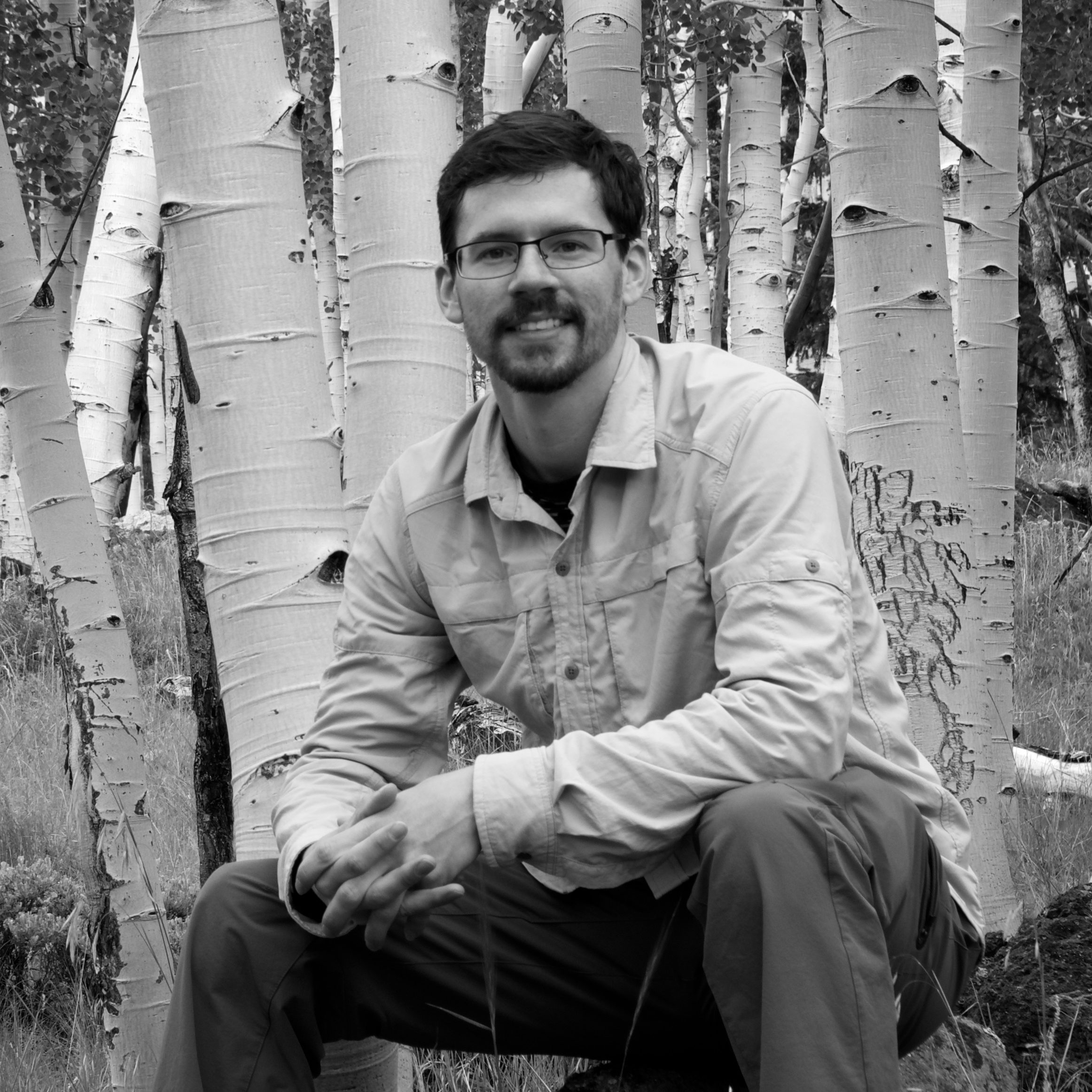 Steven Rhodes sitting in front of trees
