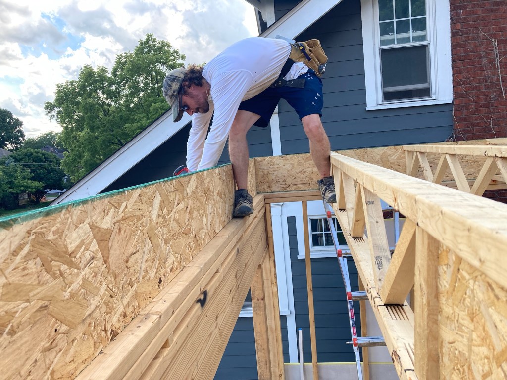 Me installing the structural floor system on Clintonville Passive House