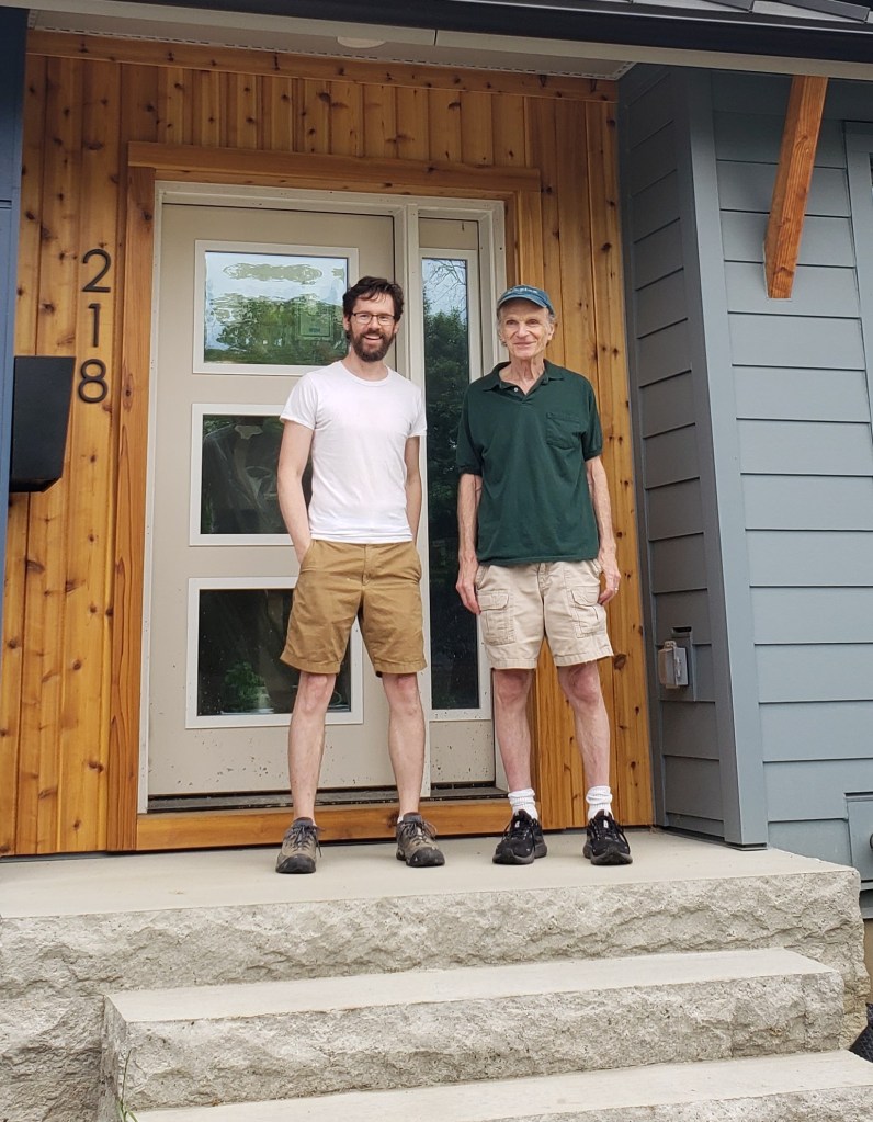 Me and Jon Alexander standing on the front stoop of Clintonville Passive House